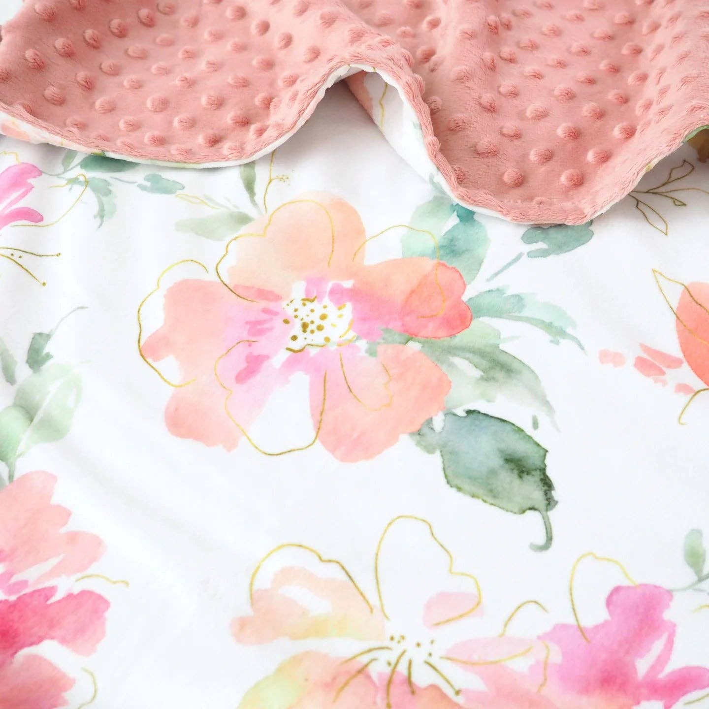 This is a large adult Honey Lemonade Blanket in a floral pattern of pinks, greens and orange.