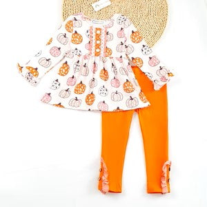 A pumpkin-themed baby outfit set with a sleeveless top featuring pumpkin patterns and orange pants with a similar pattern.