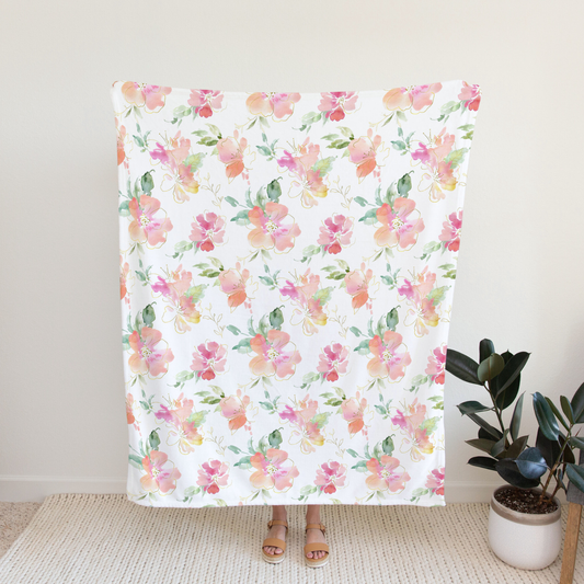 This is a large adult Honey Lemonade Blanket in a floral pattern of pinks, greens and orange. 50 x 60